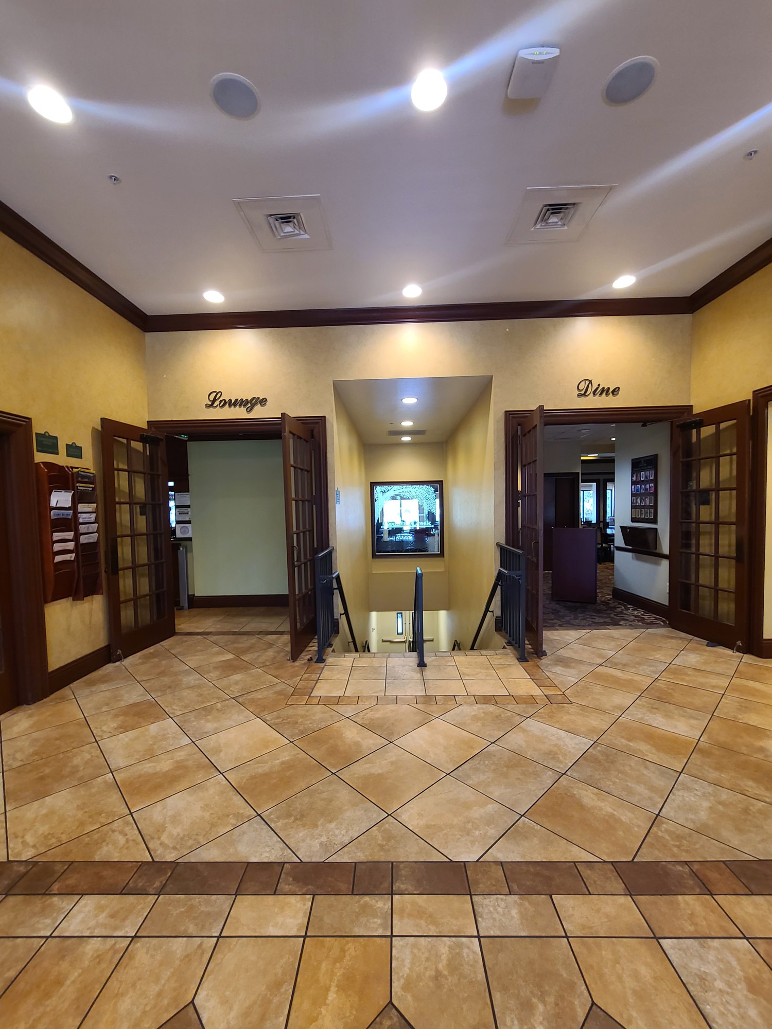 VCC clubhouse lobby before renovation with tile floor and Lounge and Dine entrances