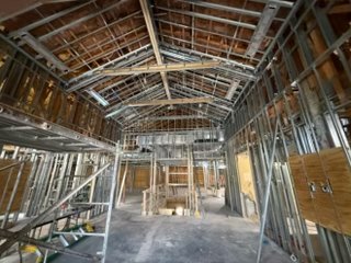 Gutted clubhouse lobby showing the new vaulted ceiling framing