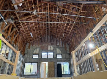 Clubhouse lobby under construction with vaulted ceiling and larger window openings