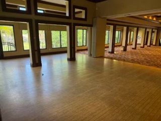 VCC dining room before renovation with carpet and support columns