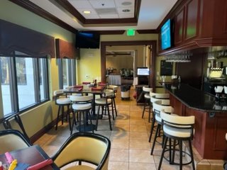 VCC bar before renovation with bar stools and televisions