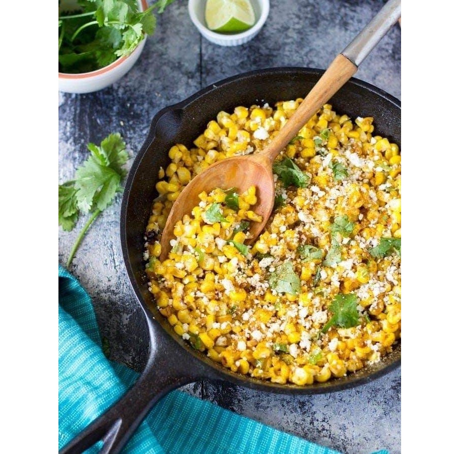 Skillet of Mexican street corn with cotija cheese and cilantro
