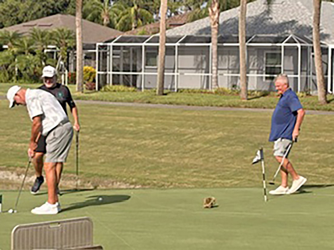 Two men putting on the green during the 2026 VCC putting contest