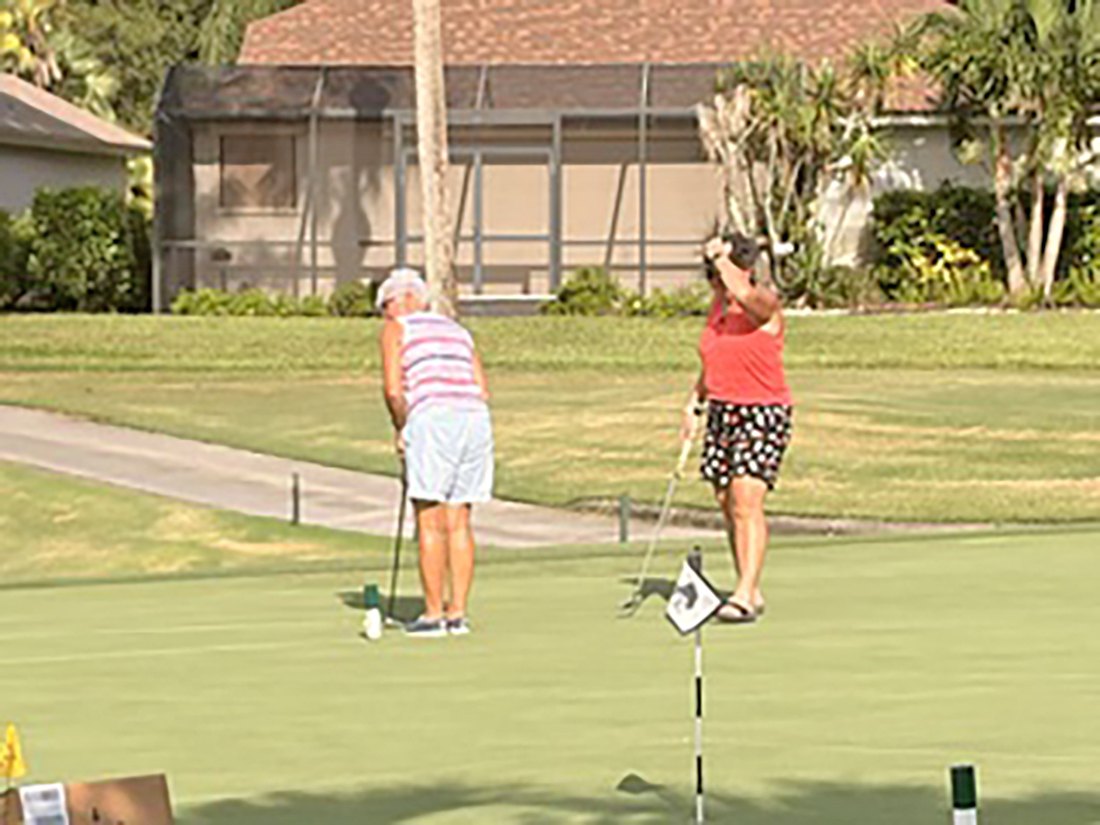 Two women putting on the green during the 2026 VCC putting contest
